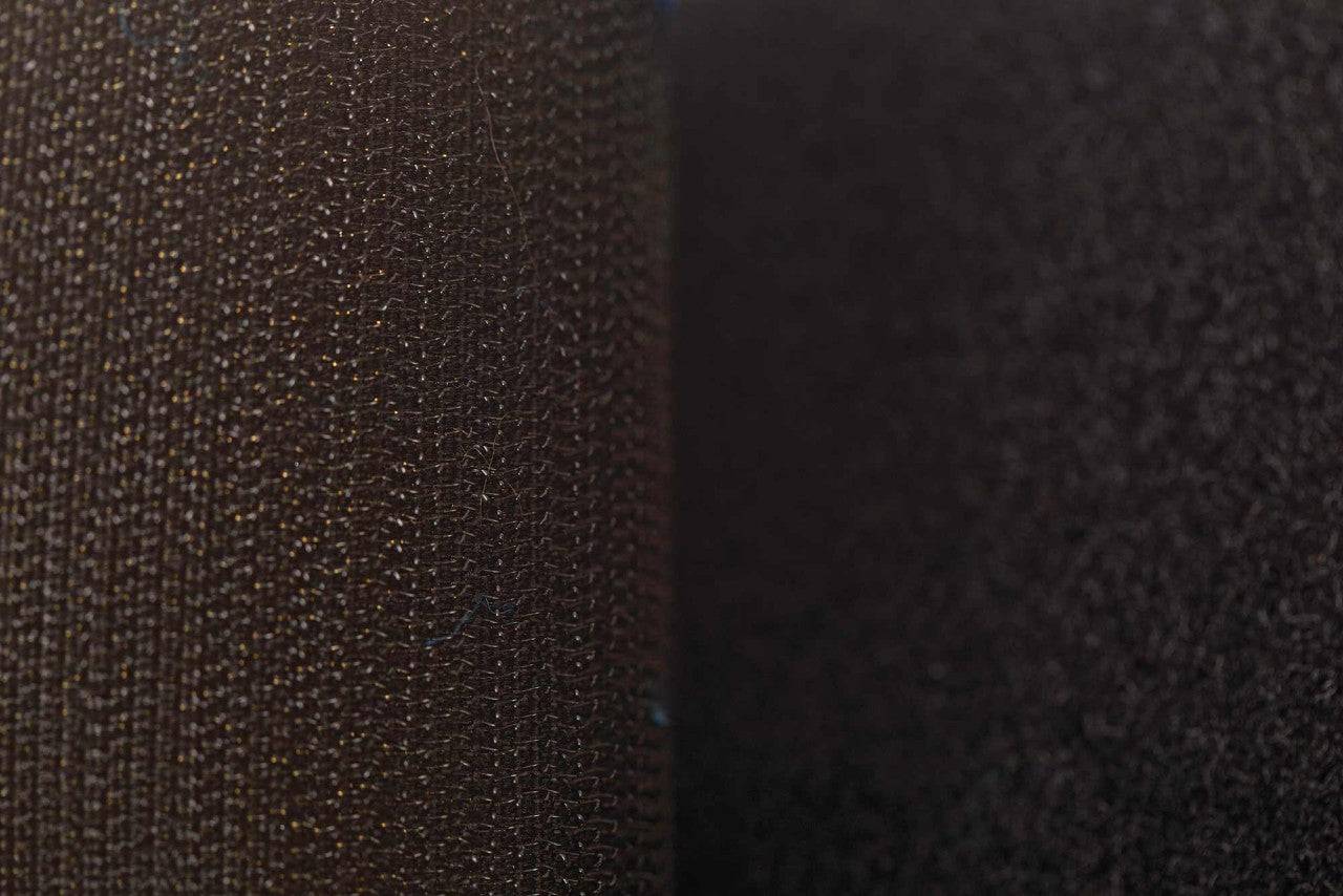 Macro view of black Velcro strap on ADIDAS Hybrid25 glove showing secure fastening system.