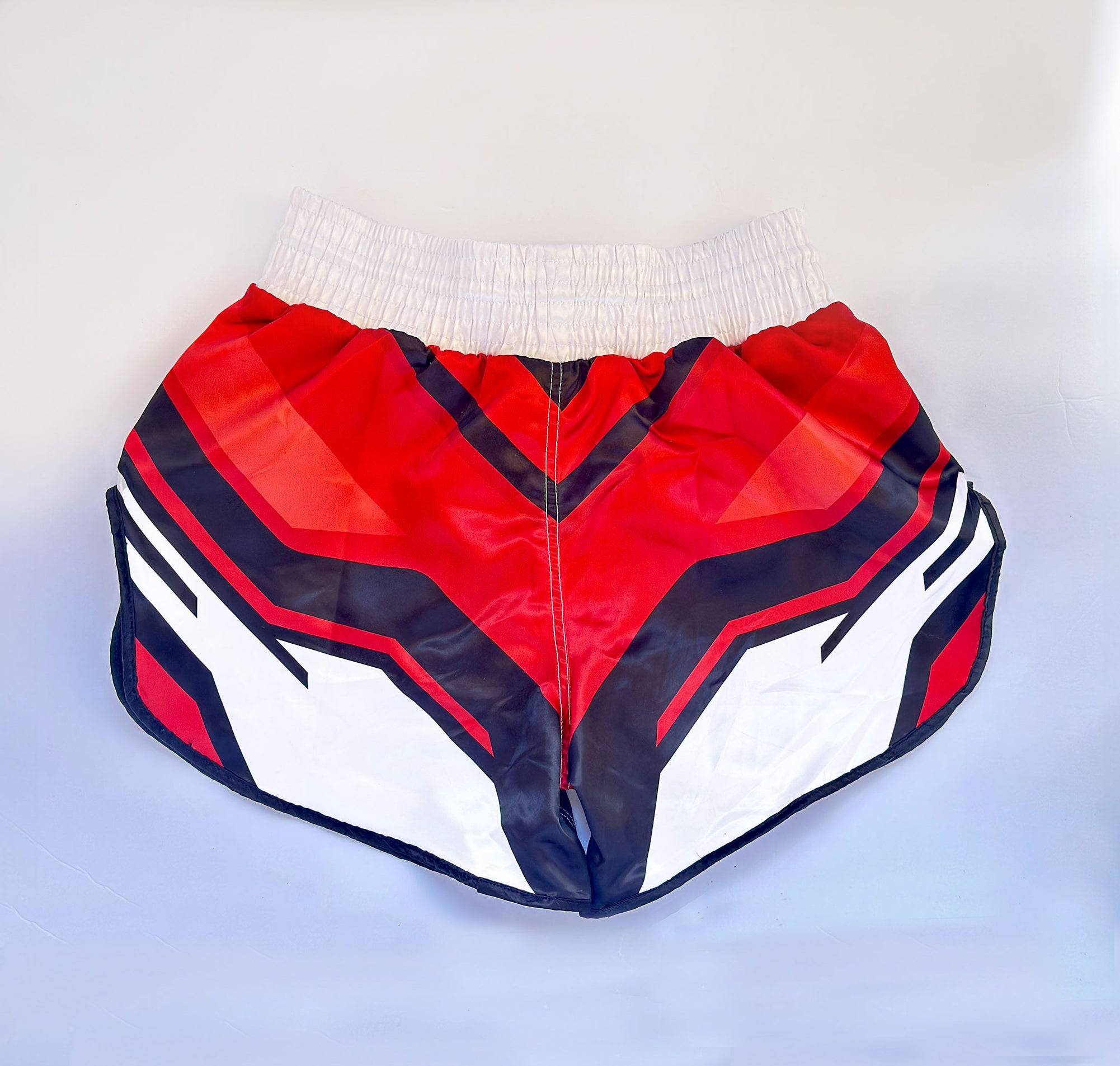 Back view of ADIDAS Kickboxing Shorts featuring red and black V-shaped design, made for flexibility in boxing and MMA workouts.