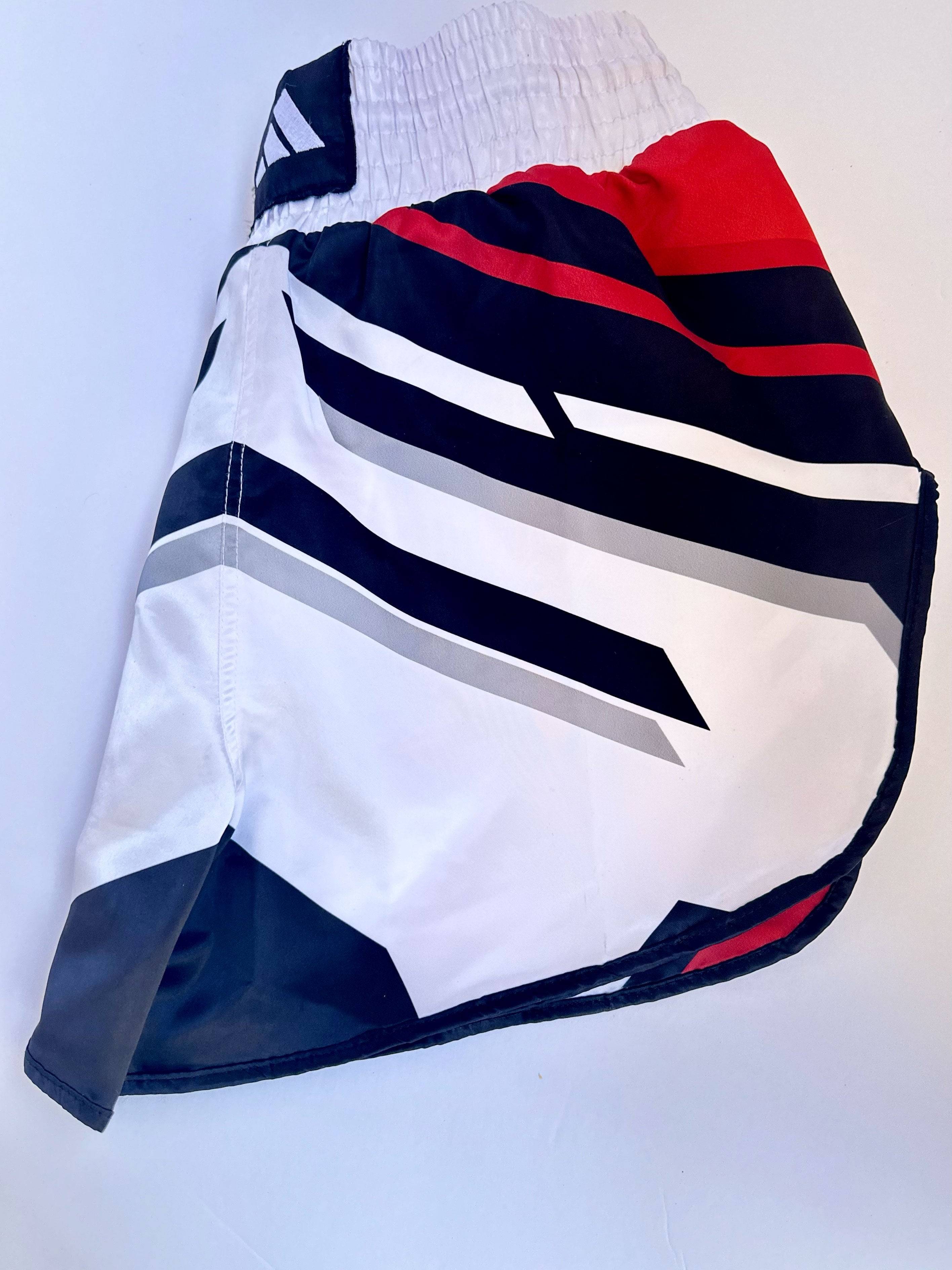 Side view of ADIDAS Kickboxing Shorts highlighting breathable fabric and dynamic stripe design for Muay Thai and MMA training.