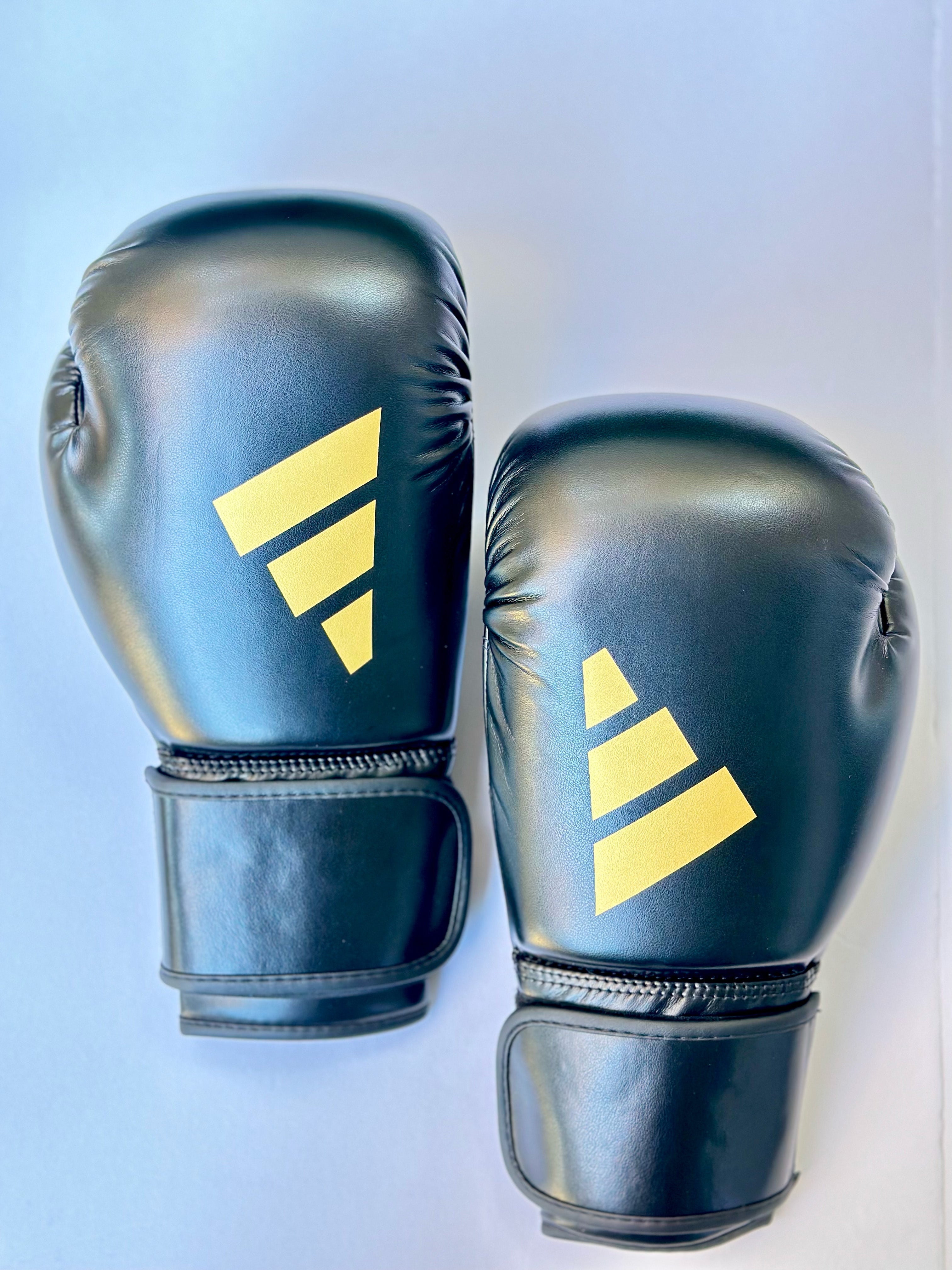 Black and gold adidas fashion boxing gloves